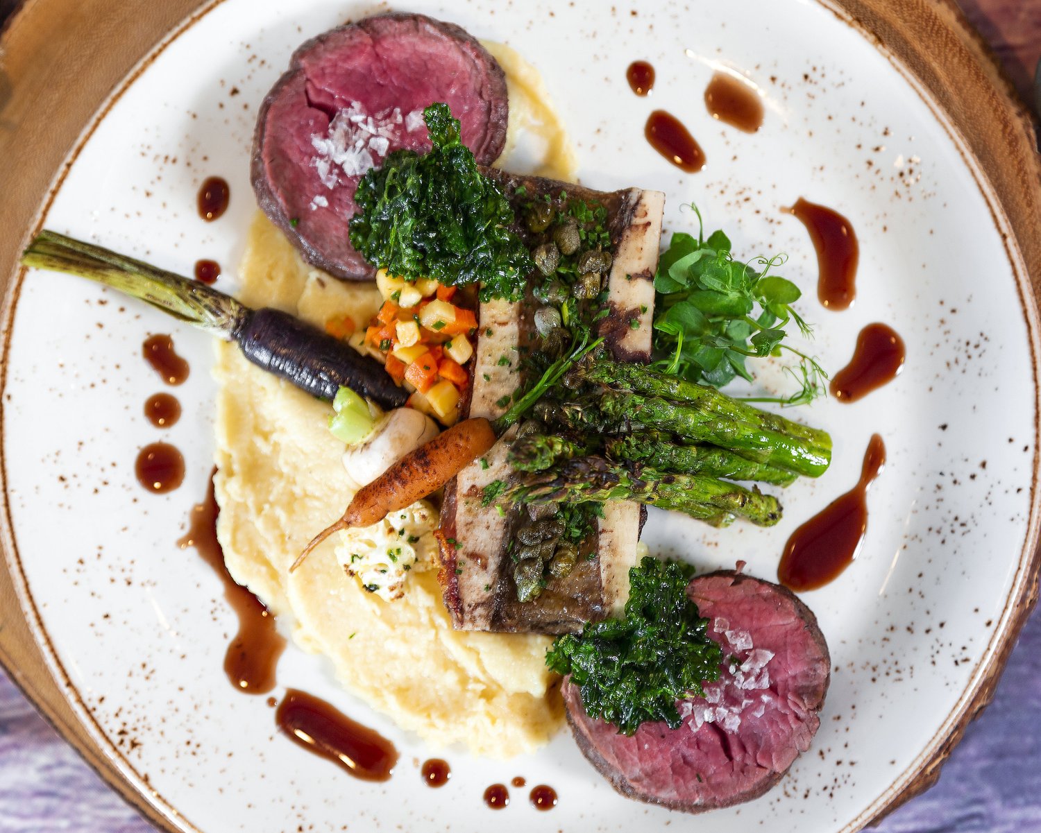 Seared beef tenderloin medallions with vegetables, gremolata and a wine reduction.