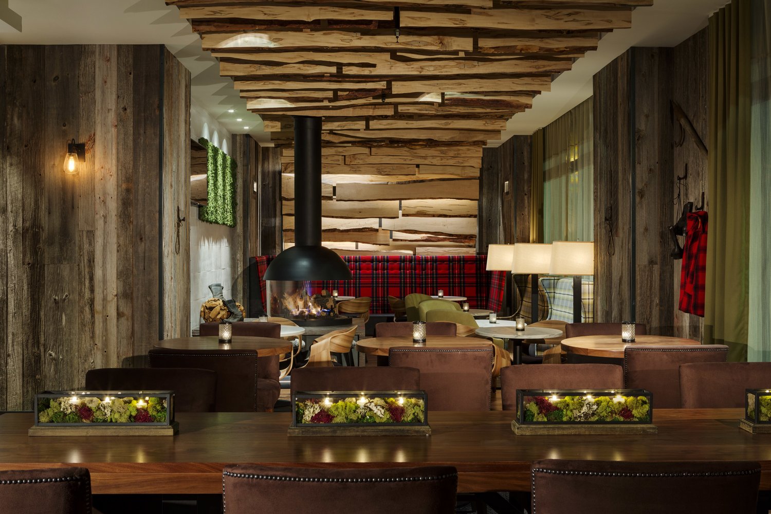 A private dining hall under a warm wood ceiling with a long row of tables.