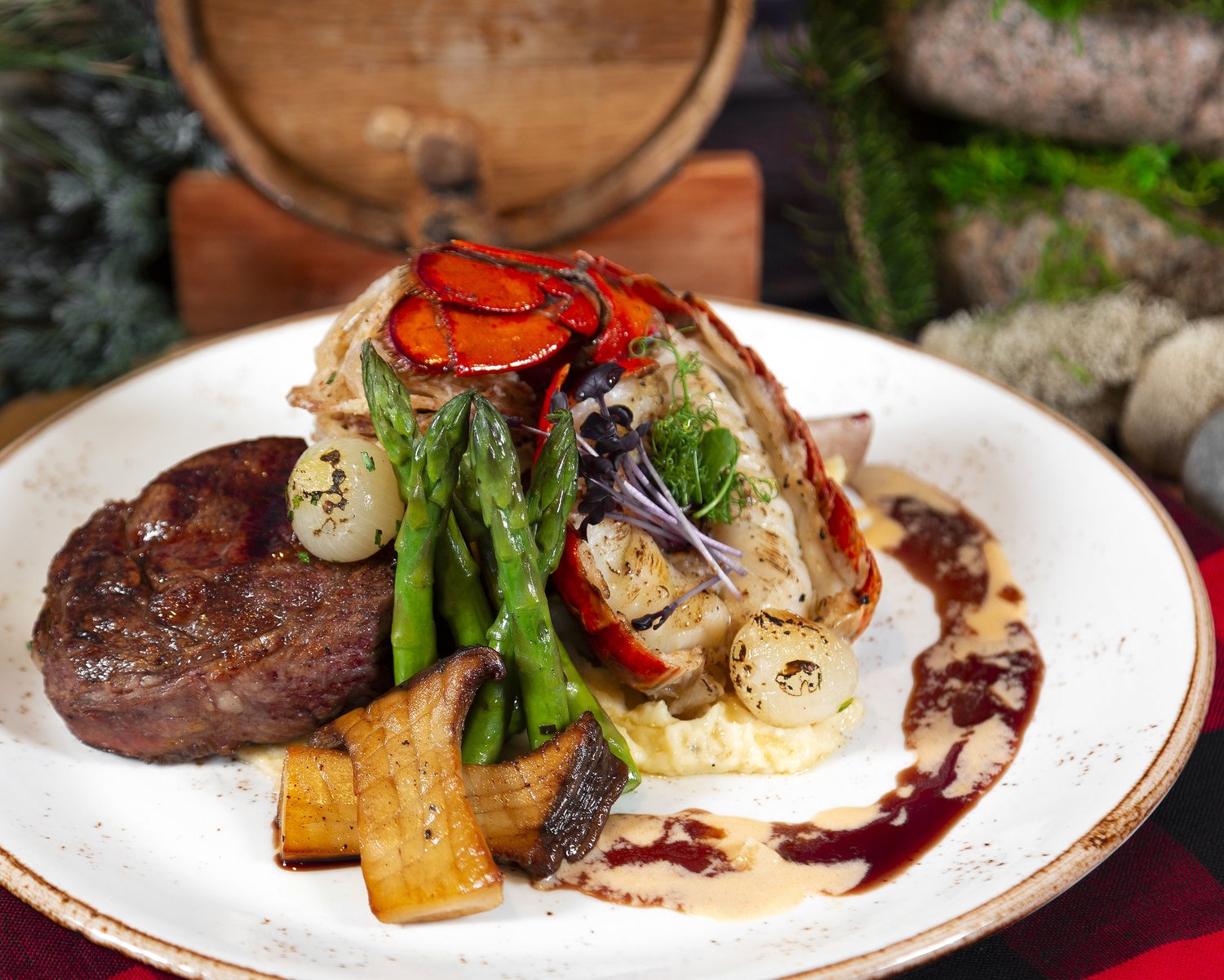A braised short rib over whipped potatoes with roasted vegetables and a red wine reduction.